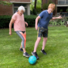 grandmother and grandson playing soccer