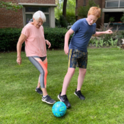 grandmother and grandson playing soccer