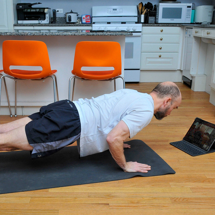person working out while looking at laptop