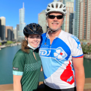 man and daughter in bicycling outfits
