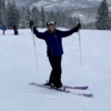 Person holding up poles on ski slope